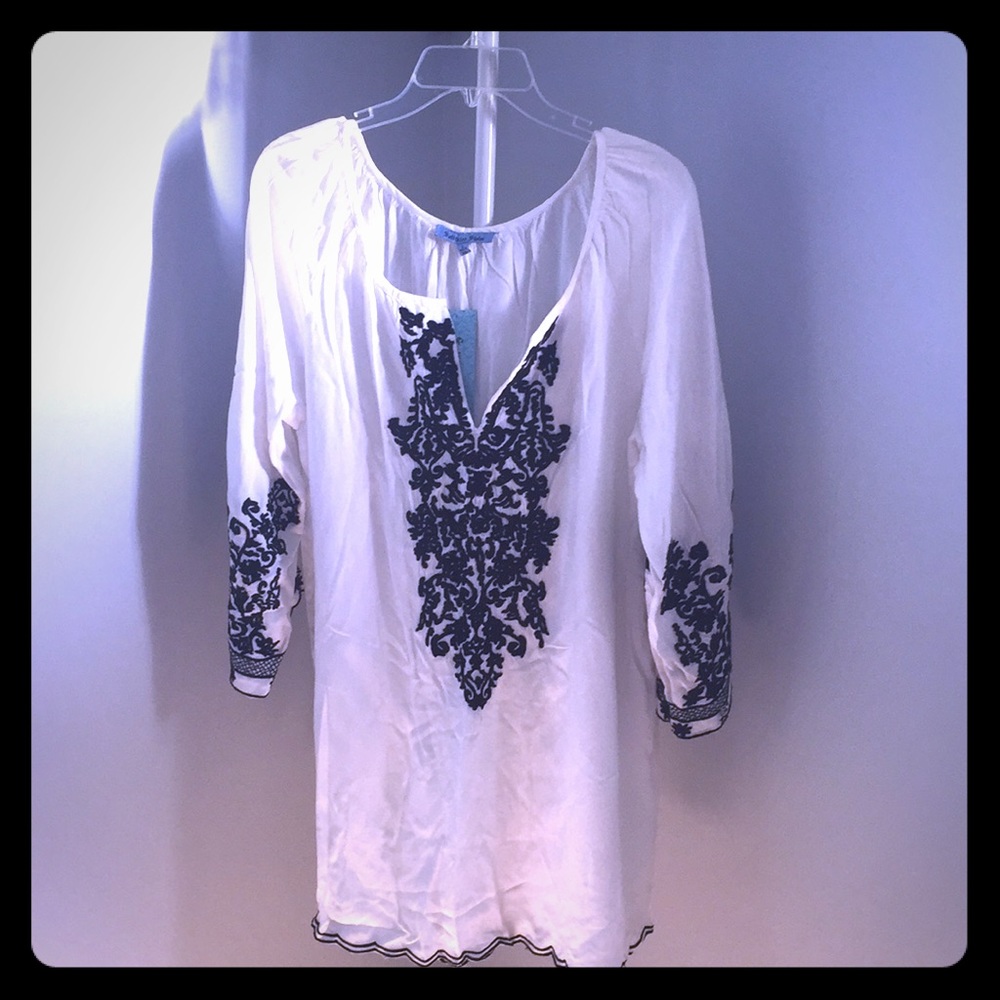 Swim cover-up with black embroidery like detail.